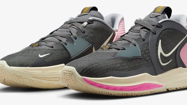 View of black and pink Nike shoes.